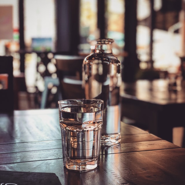 glass of water on a table in a bar
