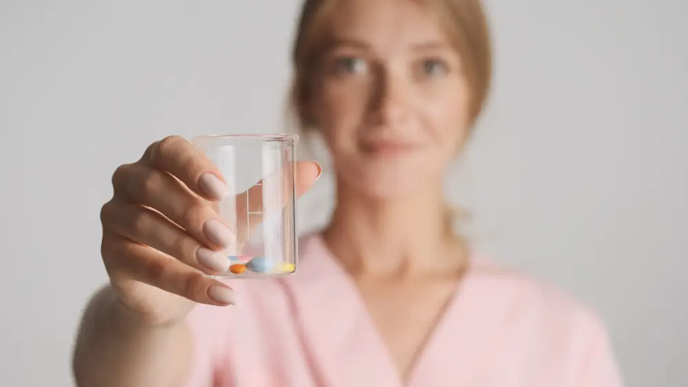 the girl holding the pills