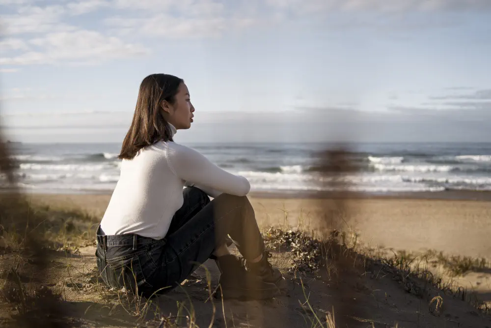 a girl sitting on the beach
