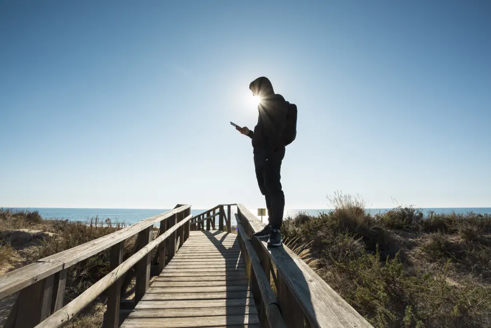 a guy standing on the beach