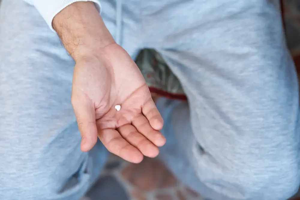 a man holding a pill