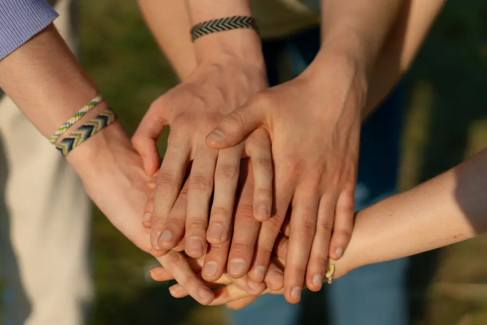 Hands stacked together in a circle