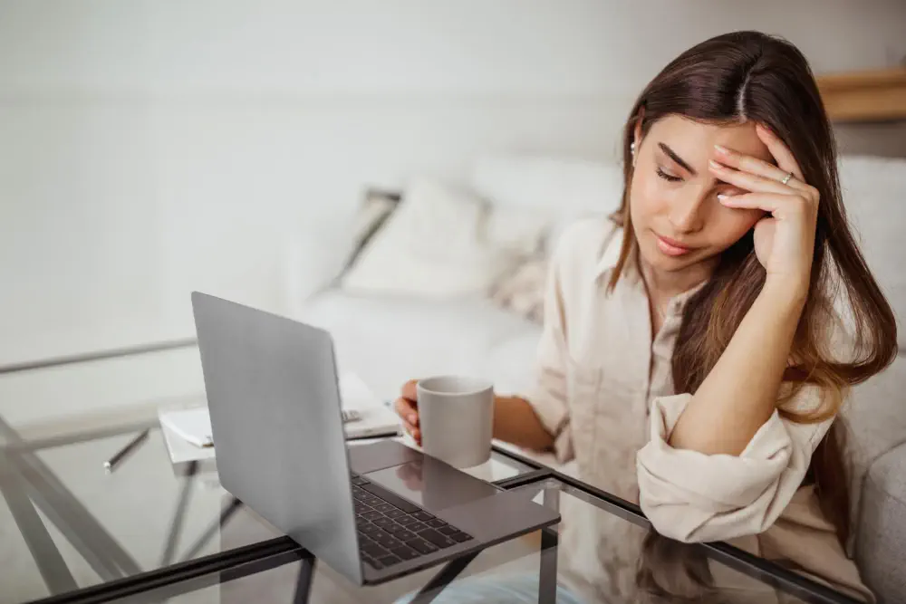 Stressed woman working on laptop